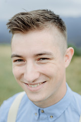 Fototapeta premium Photoshoot of the groom in the mountains. Boho style wedding photo.