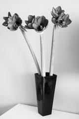 beautiful bouqet of  amaryllis in the blac vase, black and white