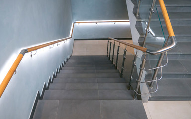 Stainless steel, glass and wood railing.Fall Protection. modern design of handrail and staircase