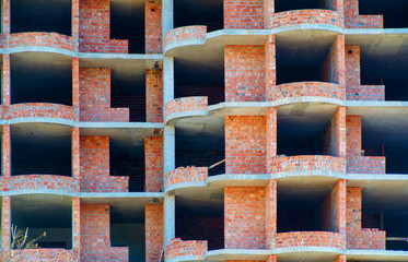 Unfinished brick multi-storey residential building, texture, background