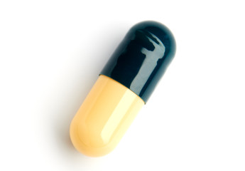 One yellow-green capsule with medication