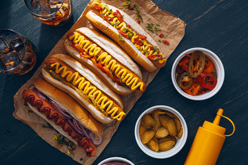 American hot dog with ingredients on a dark wooden background