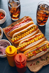 American hot dog with ingredients on a dark wooden background