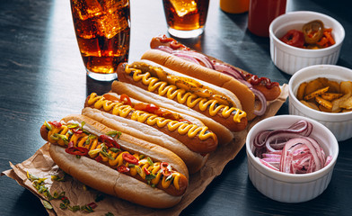 American hot dog with ingredients on a dark wooden background