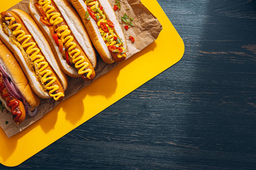 Barbecue Grilled Hot Dogs with  yellow American mustard, On a dark wooden background