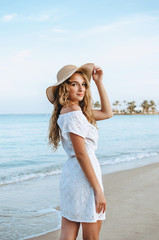 Happy woman enjoying beach relaxing joyful in summer by tropical blue water