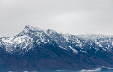Obraz na płótnie Canvas alps mountain picturesque landscape soft focus scenic view snowy peak moody foggy dramatic weather time background highland ridge