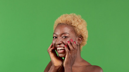 Beautiful black woman showing off her beautiful skin, concept of advertising skincare and decorative makeup