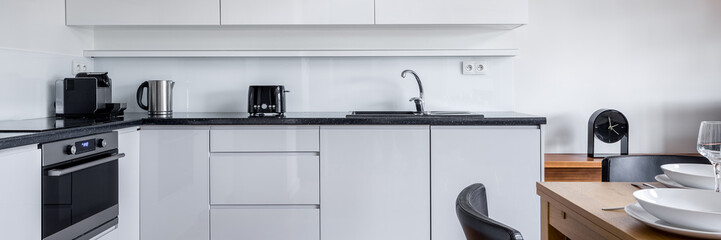 Fototapeta premium Kitchen with white furniture, panorama