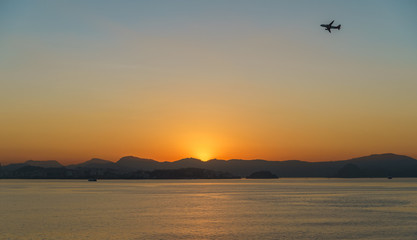 Fototapeta na wymiar Airplane flying over Rio de Janeiro at sunrise