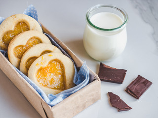 Fresh, fragrant handmade cookies, glass of milk and jar of honey. Close-up, top view. Tasty and healthy eating concept