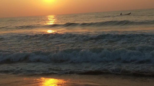 4K Sunrise over tropical island beach and palm trees. Phuket beach sea, View of beach sea on sun light in the summer. Colorful sunset over the beach in the tropical beach sea,the tropical paradise bea