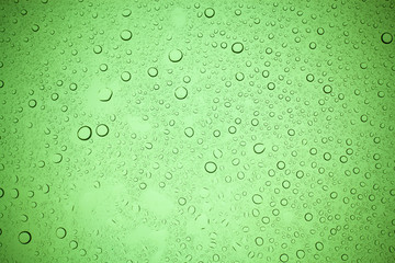 Rain droplets on green glass background, Water drops on green glass.