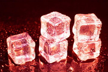 ice cubes on a reflections red light.