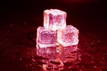 ice cubes on a reflections red light.