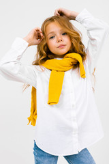 teenager girl in a white shirt and jeans posing on a white isolated background