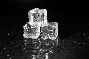 ice cubes on black table background.