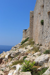 Damaged walls of ruin castle in Dubrovnik. Historical part of city. Town on the Adriatic Sea in southern Croatia. Old city of Dubrovnik. Defense against raiders and robbers