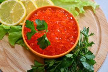 Red caviar and fresh greens