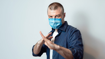 Man In Protective Mask Standing In Ready-To-Fight Pose, Gray Background