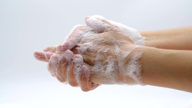 Washing hands with hand of beauty woman wash your hands at the wash basin with foam, pandemic corona covic 
