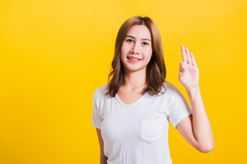 woman teen standing wear t-shirt showing gesturing ok sign
