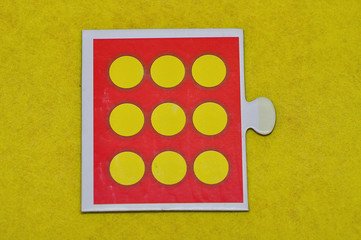 A jigsaw piece with nine dots