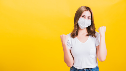 woman wearing face mask protects filter dust pm2.5, virus and air pollution her raise hands glad...