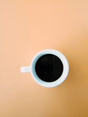 White cup of hot coffee on table