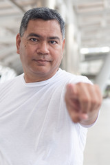 Fototapeta premium old senior man pointing at you; confident serious senior man pointing index finger for concept of selecting, choice, choosing, decision making; southeast asian senior old man model