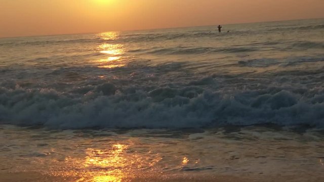 4K Sunrise over tropical island beach and palm trees. Phuket beach sea, View of beach sea on sun light in the summer. Colorful sunset over the beach in the tropical beach sea,the tropical paradise bea