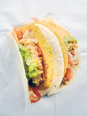beef tacos served with lettuce and fresh tomatoes
