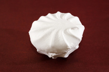 white marshmallow on a brown background. Close-up.