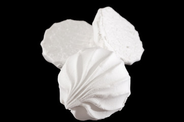 white marshmallows on a black background. Close-up.