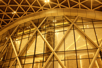Night Building structures aluminum triangle geometry on facade of modern urban architecture..blur futuristic structures