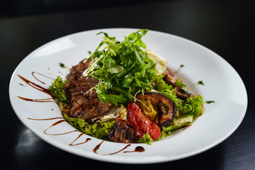 Warm salad with grilled meat and vegetables.