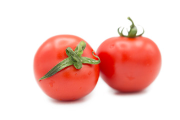 Two ripe fresh organic tomatoes with dew drops isolated on white background.	