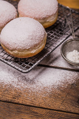 Traditional Polish donuts on wooden background. Tasty doughnuts with jam