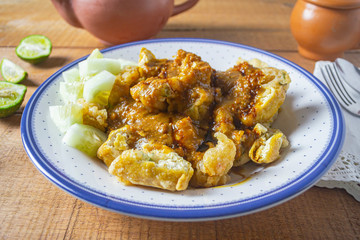 Delicious batagor or meatballs tofu is one of the popular indonesian traditional foods. Made from fish, tofu and peanut sauce. on wooden background