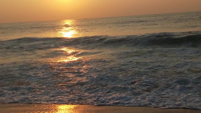 4K Sunrise over tropical island beach and palm trees. Phuket beach sea, View of beach sea on sun light in the summer. Colorful sunset over the beach in the tropical beach sea,the tropical paradise bea