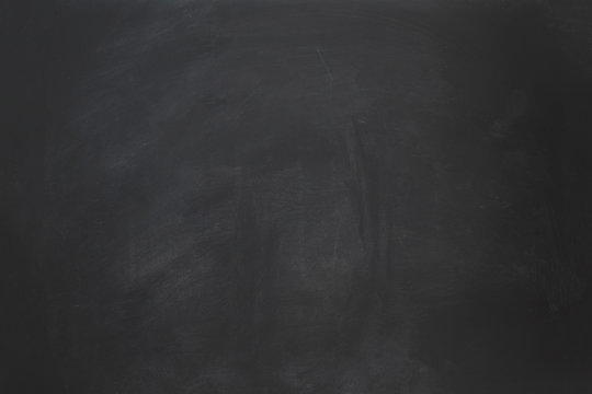 empty black chalkboard background with chalk smudge texture