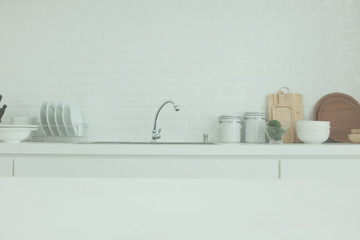 White wood table top on blur kitchen window background, panoramic banner - can be used for display or montage your products (or foods)