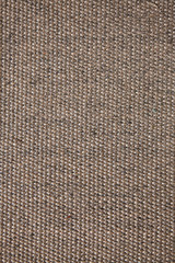 The surface texture of a natural Mat (straw, rope, or other natural material).
