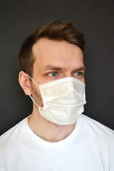 man in medical mask on a black background