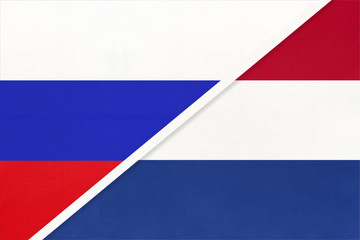 Russia vs Netherlands national flag from textile. Relationship and partnership between two countries.