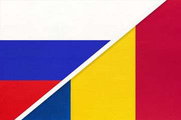 Russia vs Romania national flag from textile. Relationship and partnership between two countries.
