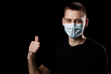 male with medical mask for coronavirus pandemic infection COVID-19 shows thumb up