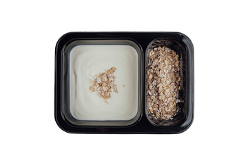 Healthy lunch at workplace. Take away meals in black containers with cutlery on gray table