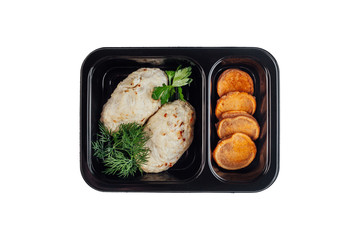 Healthy lunch at workplace. Take away meals in black containers with cutlery on gray table