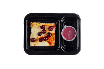 Healthy lunch at workplace. Take away meals in black containers with cutlery on gray table